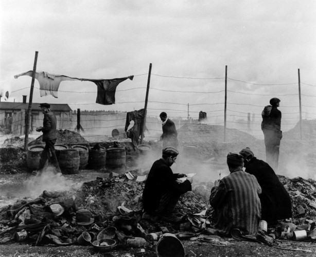 Những tù nhân được trả tự do đang bới một đống rác ở Dachau, Đức năm 1945. Nhiếp ảnh gia Lee Miller viết rằng: “Những tù nhân này bới các đống rác, trong đó có cả những thứ đang bốc cháy, để cố tìm lấy thứ gì đó còn tử tế hơn những thứ họ đang mặc”.