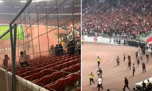Chứng kiến đội nhà thua ngược 2-3 trước Malaysia ở lượt trận ra quân vòng loại World Cup 2022, các cổ động viên (CĐV) quá khích của Indonesia đã ném pháo sáng từ các tầng trên cao xuống khu vực chỗ ngồi của cổ động viên Malaysia. Ảnh: Foxsports.