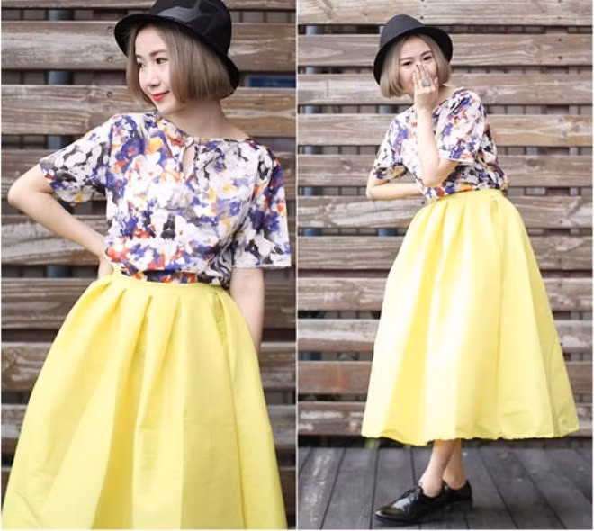 Phong cách, nổi bật và rực rỡ với chân váy midi dáng chữ A bồng bềnh cùng áo sơ mi cách điệu họa tiết hoa.