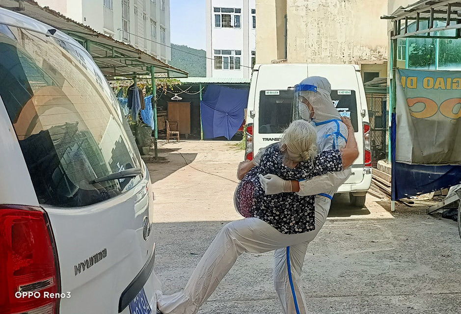 Hình ảnh Thượng úy Nguyễn Thanh Bình - Hải Đội 2 BĐBP Đà Nẵng bế bệnh nhân mắc Covid-19 đã lớn tuổi từ tầng 4 khu cách ly xuống xe để đi điều trị. Đó không chỉ là nhiệm vụ, trách nhiệm mà quan trọng hơn là tình thương giữa quân và dân. Ảnh: Nguyễn Tống Khiêm