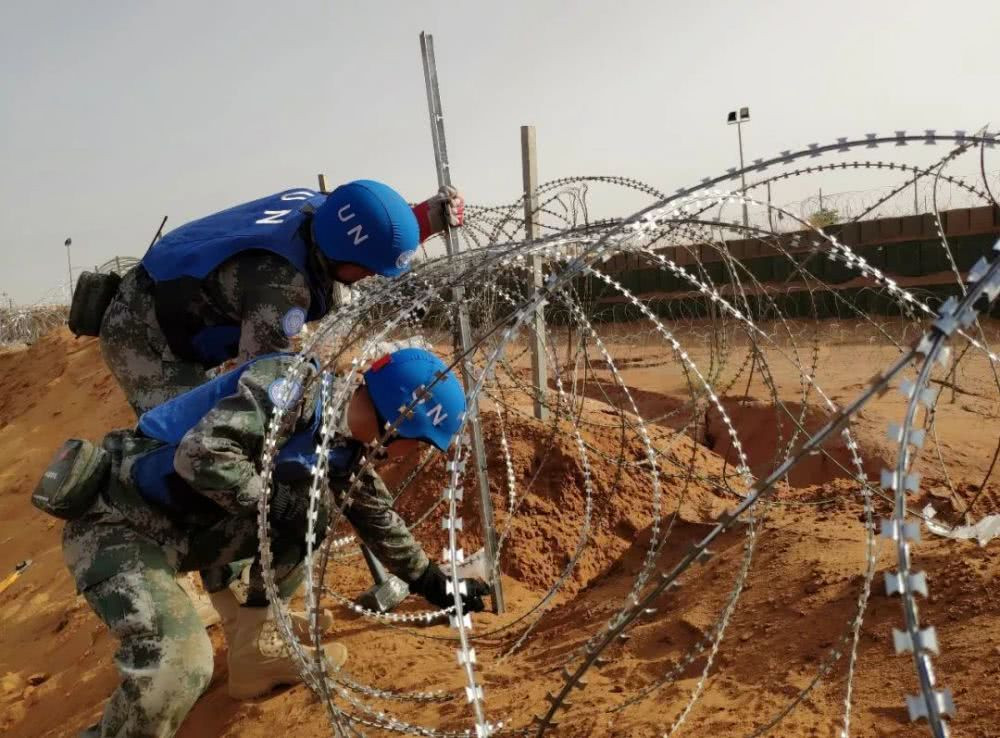 Lực lượng gìn giữ hoà bình Trung Quốc kiểm tra lại hệ thống hàng rào xung quanh doanh trại vào buổi sáng sau vụ tấn công khủng bố giết chết 8 người địa phương - có vẻ vụ tấn công không nhắm vào doanh trại của Trung Quốc đặt tại đây. Nguồn ảnh: QQ.