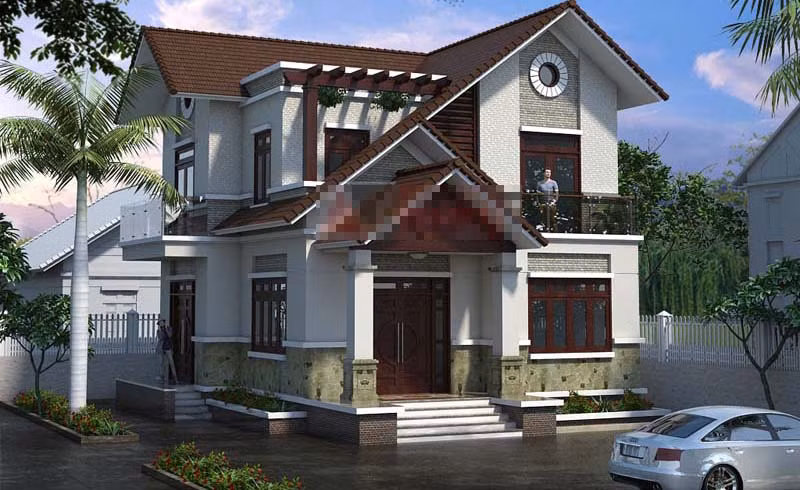 Nhà 2 tầng mái ngói dốc độc đáo nổi bật với gam màu trầm. Khối kiến trúc chắc chắn cùng chi tiết phào chỉ nhấn nhá tăng thêm điểm cộng cho không gian. Ảnh: Angcovat.