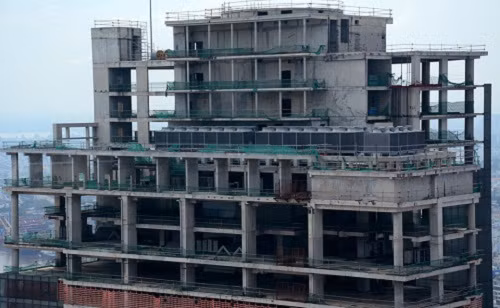 Dù đã được cất nóc từ lâu, tòa nhà Saigon One Tower vẫn còn dở dang, nguyên nhân là do thiếu vốn. Ảnh: Zing.