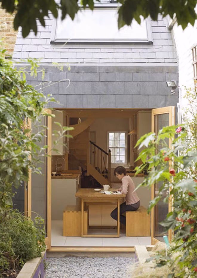 Do nhà ống 3 tầng sâu nên chủ nhà dành 1/3 diện tích đất để làm sân vườn phía sau với lối đi giữa hai hàng cây. Ảnh: Ktshanoi.