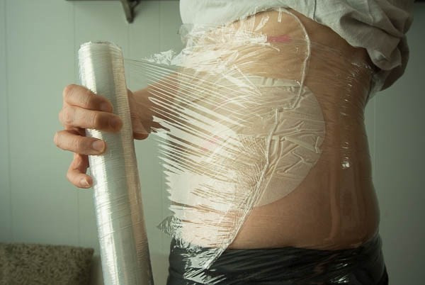 Sau khi massage, dùng bao nilon quấn quanh bụng bạn khoảng 3 lớp (chú ý không quấn chặt).