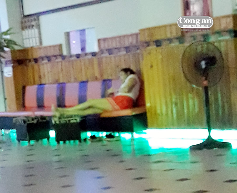 Cô gái ăn mặc hở hang ngồi đợi khách massage.