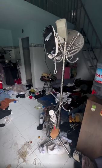 Đồ đạc và rác được quăng bừa, chất đống lên từ cửa phòng, vương vãi khắp sàn nhà, vứt đầy trên cả chỗ ngủ lẫn bàn trang điểm.