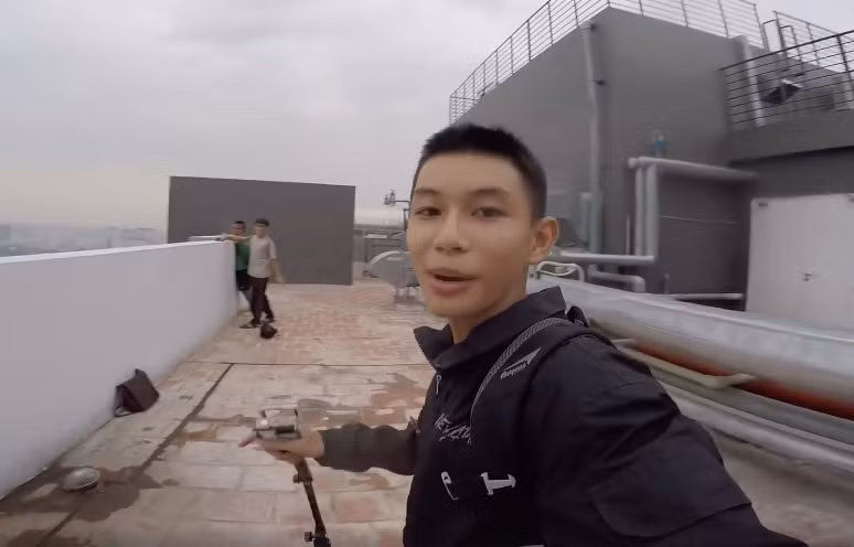 Không ít người lạnh xương sống với hình ảnh nhóm các bạn nam đứng cheo leo trên nóc nhà cao tầng không thiết bị bảo hộ này.