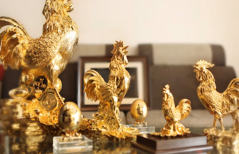 Không chỉ chơi gà sống, các đại gia Việt còn có thú chơi tượng gà phủ vàng. Đặc biệt là vào vào tết Đinh Dậu 2017, sản phẩm tượng gà phủ vàng, dát vàng được sản xuất với số lượng lớn, mẫu mã, kiểu dáng cũng đa dạng, phong phú hơn. (Ảnh Mavang)