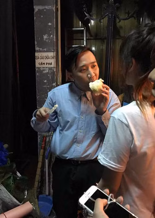 Nhận được chiếc bánh kem từ vợ, Trấn Thành vui vẻ thưởng thức. (Ảnh: FBNV)