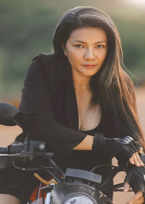Nữ diễn viên phim "Mùa len trâu" tạo dáng bên xe moto.