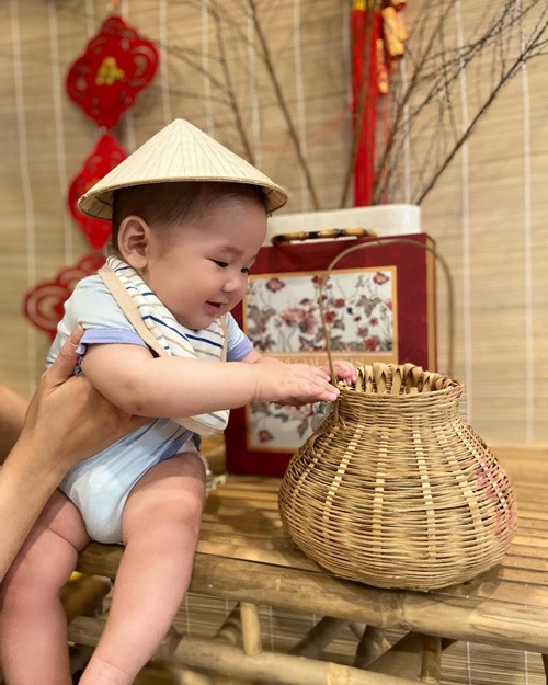 "Chiều nay em đi câu cá về cho má nấu canh chua", Minh Hằng chú thích cho bức ảnh bé Mỡ đội nón, nghịch giỏ câu cá.