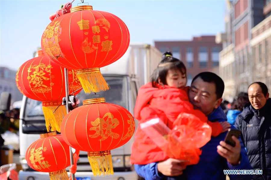 Mọi người đi sắm Tết trong một khu chợ ở Thanh Đảo, tỉnh Sơn Đông, hôm 26/1.