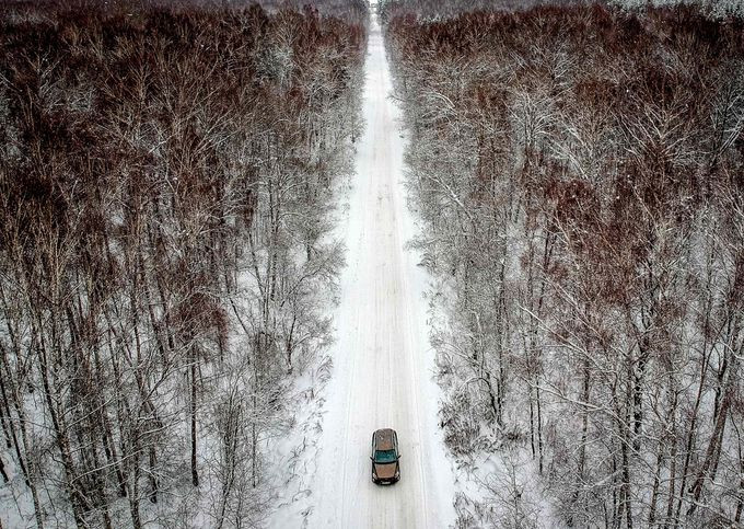 Chiếc ô tô đi qua khu rừng bị tuyết bao phủ gần làng Meshcherskoye, ngoại ô thủ đô Moscow, Nga, ngày 6/1. Ảnh: Getty.