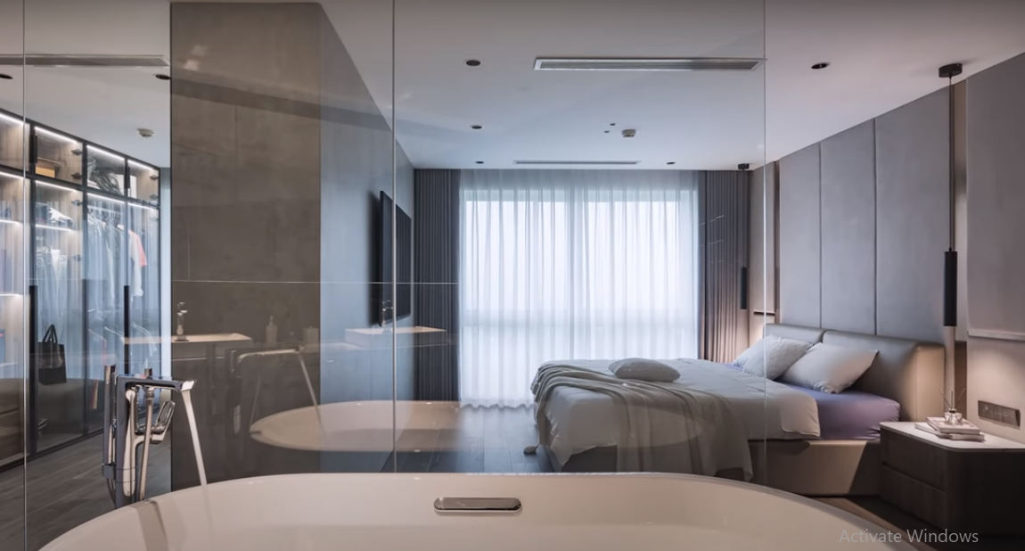 Phòng ngủ thiết kế đơn giản, hiện đại có cửa kính lớn nhìn ra bên ngoài.