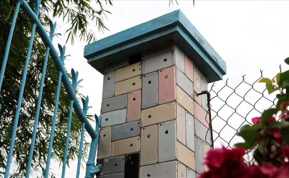 Những chiếc vỏ iPhone được ốp chắc chắn vào cột cổng. Ảnh: Lao động