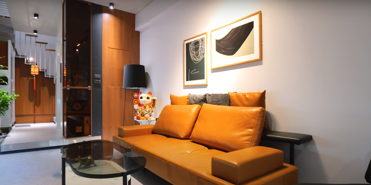 Không gian phòng khách ấm cúng với màu nâu của gỗ và ghế da kết hợp màu nâu của tường.