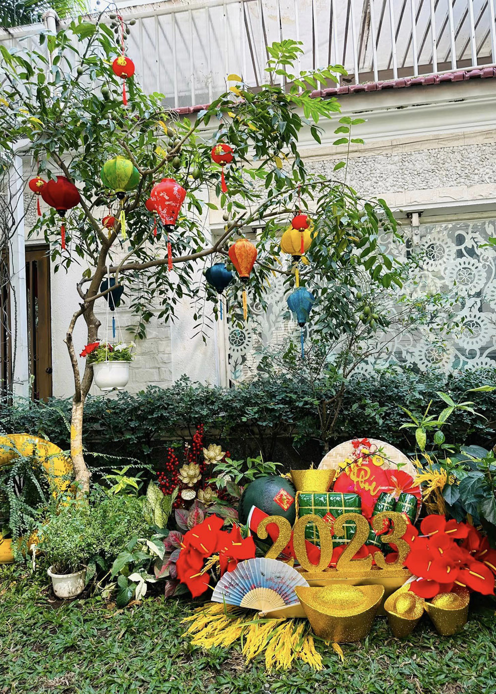 Vy Oanh treo đèn lồng lên một số cây xanh và thiết kế tiểu cảnh gồm bánh chưng, dưa hấu, bánh tét...