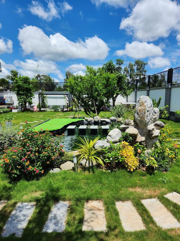 Khuôn viên sân vườn có cả tiểu cảnh, hồ nuôi cá, thảm cỏ xanh mướt. Ảnh: FBNV
