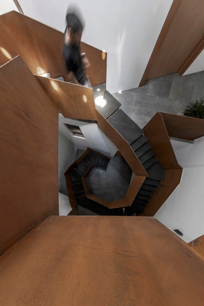 Điểm nhấn của ngôi nhà có lẽ chính là cầu thang vô định hình ở trung tâm được làm bằng kết cấu thép 10mm và mặt bậc được bọc hạt cao su EPDM.
