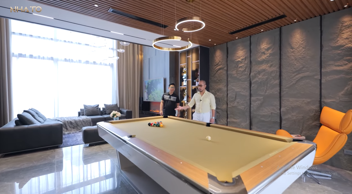 Ở mỗi tầng, kiến trúc sư đều tạo điểm nhấn nhất định và thiết kế những khu vực giải trí phù hợp. Trong phòng khách ngoài sofa còn có một bàn bi-a lớn.