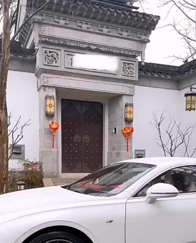 Cổng nhà xây kiên cố với cánh cửa gỗ lớn mang đậm phong cách xưa.