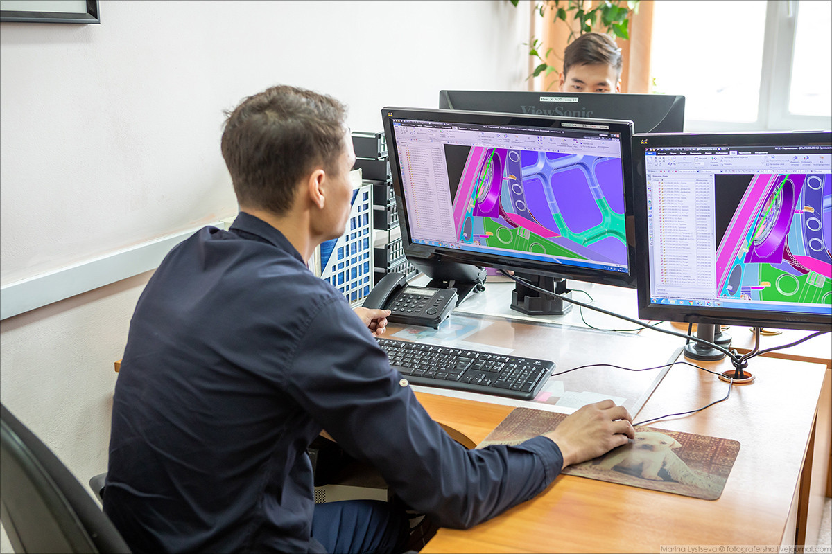 Các chuyên gia IT đang thực hiện phần việc liên quan tới thiết kế tổng thể trên máy tính. Nguồn ảnh: Marina Lystsev