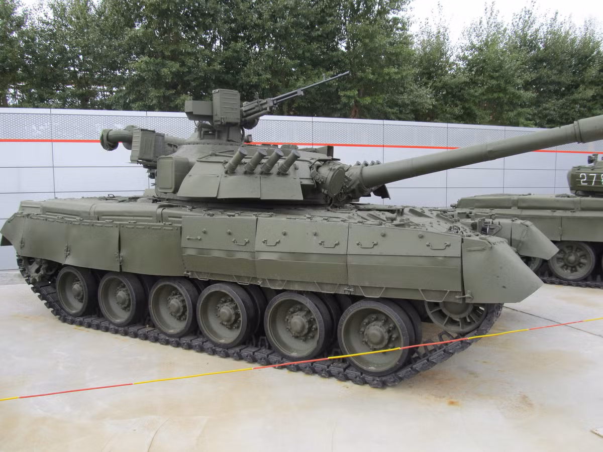 T-80UD cũng được trang bị giáp phản ứng nổ Kontakt-1 hoặc Kontakt-5, nhưng có bổ sung thêm giáp váy quanh thân và cả tháp pháo. Nguồn ảnh: Wikipedia