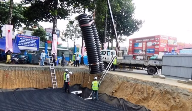 Công trình có quy mô dài 10m, rộng 9m, sâu khoảng 2,5m, được lắp đặt bằng các môđun cross-wave là những kết cấu bằng nhựa và đây là công nghệ mới được sử dụng. Hồ điều tiết nói trên được xây dựng ngầm trong lòng đất có dung tích chứa 109m3 nước mưa, khoảng 95% lượng nước này có thể để sử dụng tưới cây xanh và phòng cháy chữa cháy. Ảnh Ngô Bình/TPO.