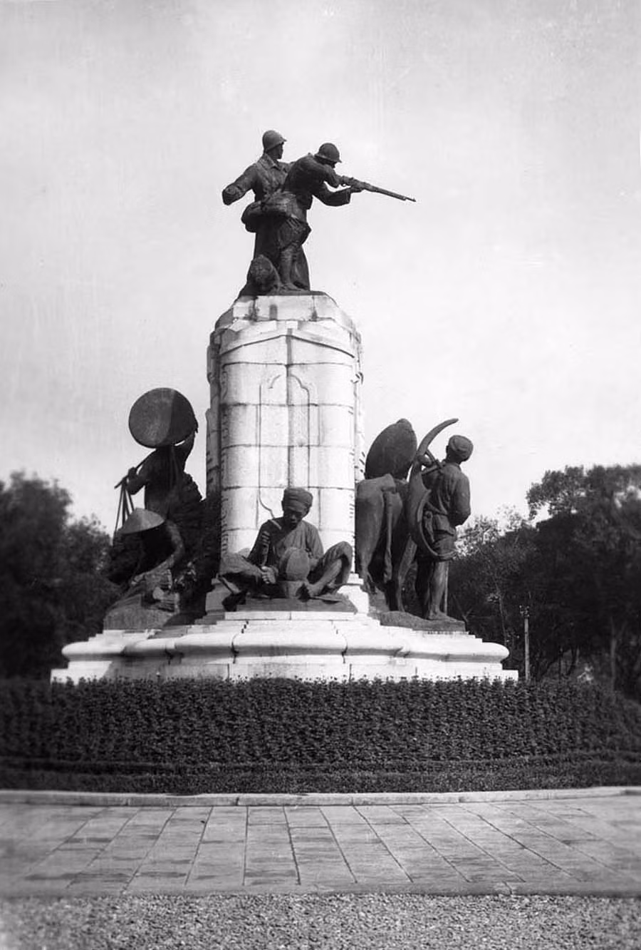 Theo đồ án, "Sĩ" là một thanh niên cắp tráp đeo ống quyển, tư thế như đang tới trường. "Nông" là anh thợ cày gánh cày chìa vôi đi sau con trâu. "Công" là anh phu xe còng lưng kéo chiếc xe tay. "Thương" là cô gái gánh đôi quang thúng đi chợ.