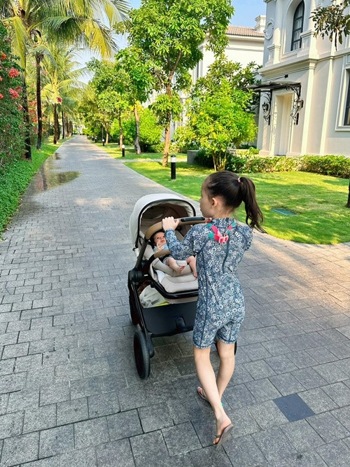 Cô nhóc giúp mẹ đẩy xe nôi bé Mia trong chuyến du lịch Đà Nẵng.