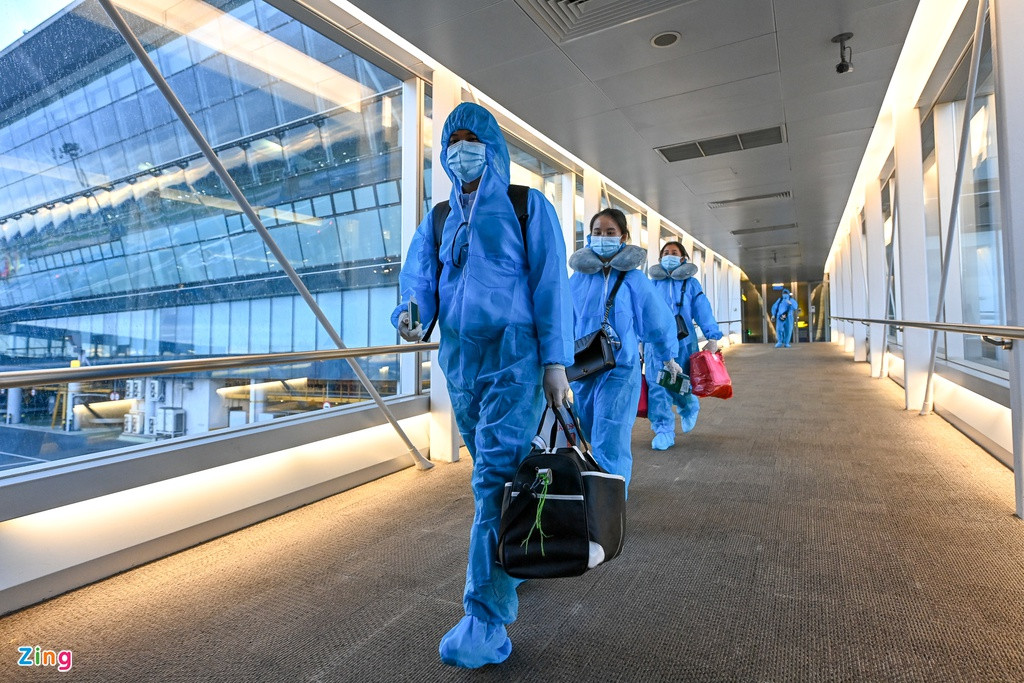 Hành khách lên máy bay đều mặc trang phục bảo hộ.