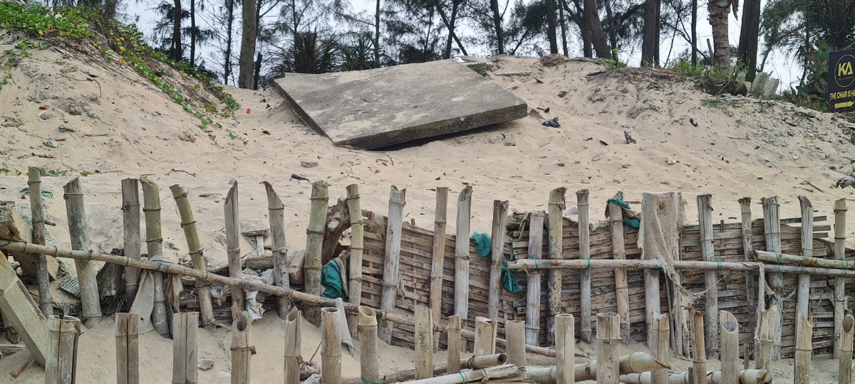 Cát bị cuốn đi để lại những điểm xói lở, được gia cố tạm.