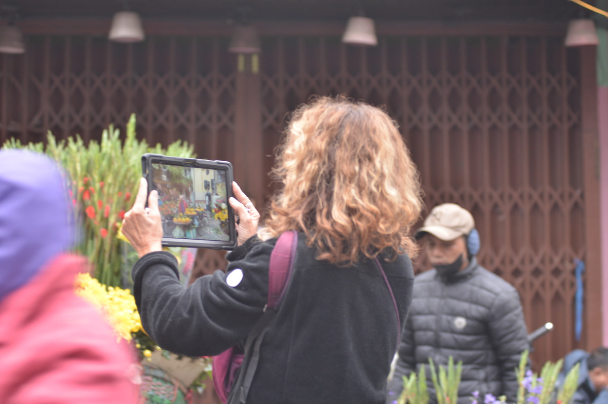 Du khách nước ngoài thích thú với cảnh buôn bán tấp nập tại chợ Hàng Bè trong sáng 30 Tết.