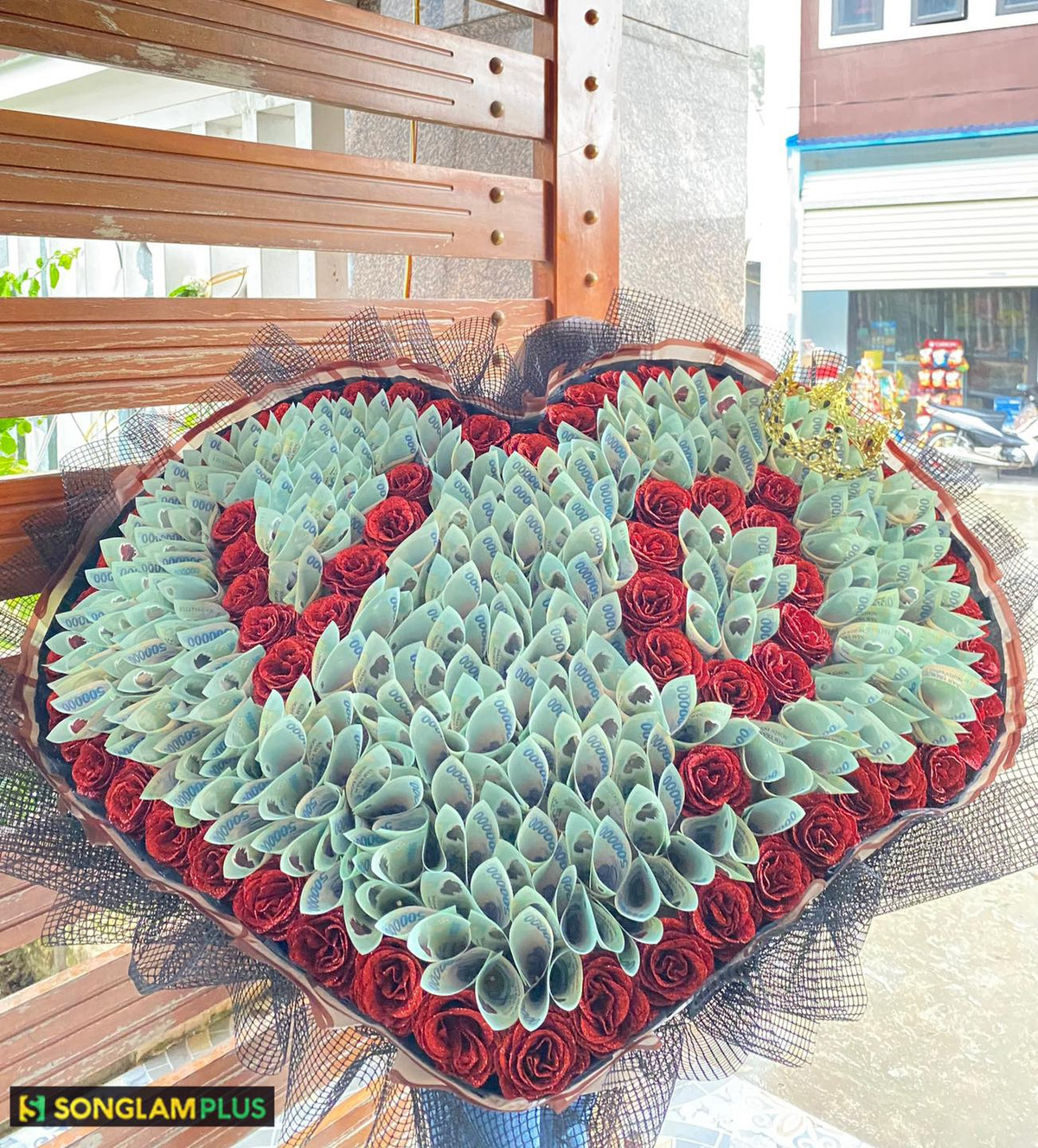 Điểm nhấn của bó hoa là những miếng vàng lấp lánh, được cắm xung quanh để tạo thành hình tròn khổng lồ.