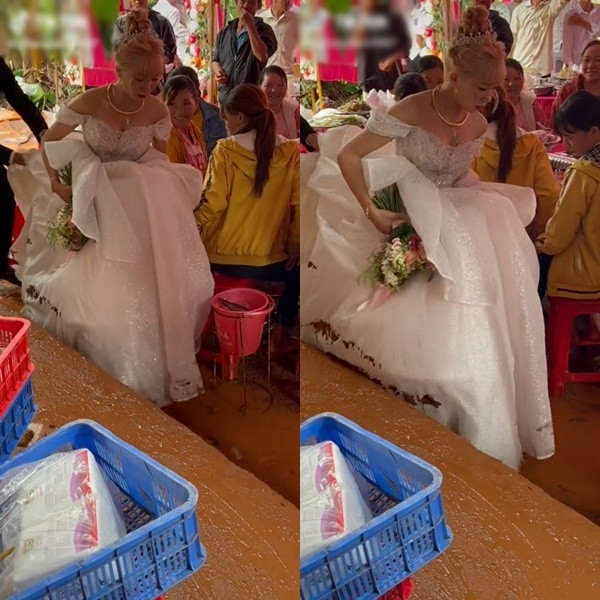 Chú rể dù đã cố gắng giúp vợ nâng cao váy nhưng vẫn chẳng thể tránh được vì đất quá lầy lội.