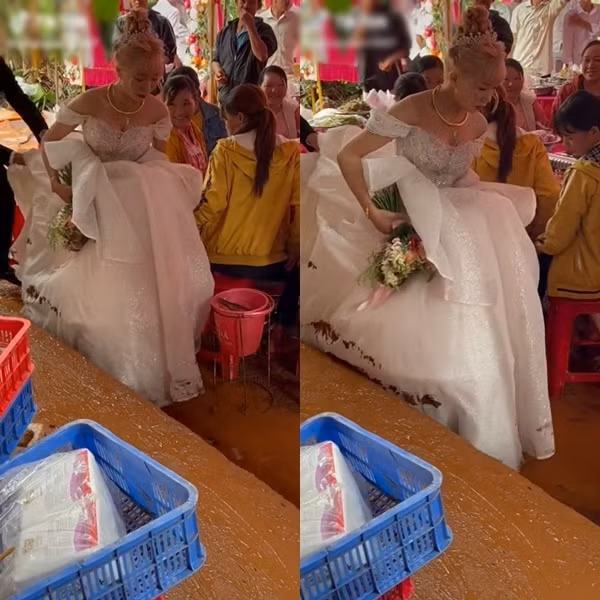 Chú rể dù đã cố gắng giúp vợ nâng cao váy nhưng vẫn chẳng thể tránh được vì đất quá lầy lội.