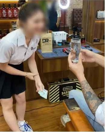 Tương tự như đoạn clip trên, một đoạn clip khác ghi lại một người cầm cốc bia đến phía cô gái đang ở quầy bán nước. Lúc này, cô gái dùng tay chấm mút vào ly bia.