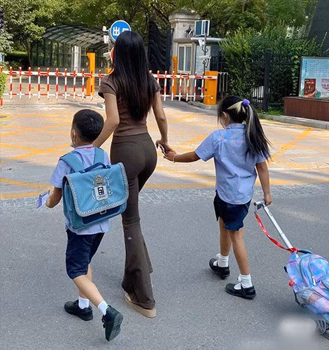 Bên cạnh trang phục váy ôm sát cơ thể, nhiều bà mẹ trẻ còn diện quần ống loe phối với áo thun có độ co giãn vừa vặn.