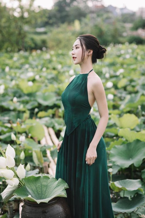 Trong khoảnh khắc chụp ảnh hoa sen của mình, Hồng Nhung chọn trang phục áo dài trắng và váy yếm màu xanh tôn lên vóc dáng và làn da trắng không tì vết của mình. Từ cách tạo dáng đến thần thái, biểu cảm trước ống kính đều “đốn tim” người xem bởi nhan sắc xinh đẹp, thanh tú cùng đôi mắt hút hồn.