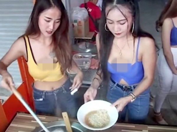 Hai cô gái khác đứng bán quán ăn ăn vận mát mẻ, hở rốn còn trễ nãi, khoe ngực khiến nhiều người lắc đầu. Ảnh Internet