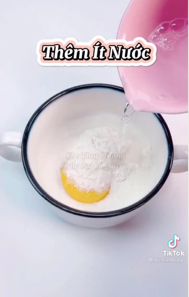 Tiếp theo, cho hỗn hợp bột phía trên vào một túi nilon có khoét lỗ nhỏ. Khi nước trong chảo đã sôi, chỉ cần dùng tay nặn bột thành hình vòng tròn là đã tạo ra những sợi mì vàng ươm và không bị dính vào nhau.