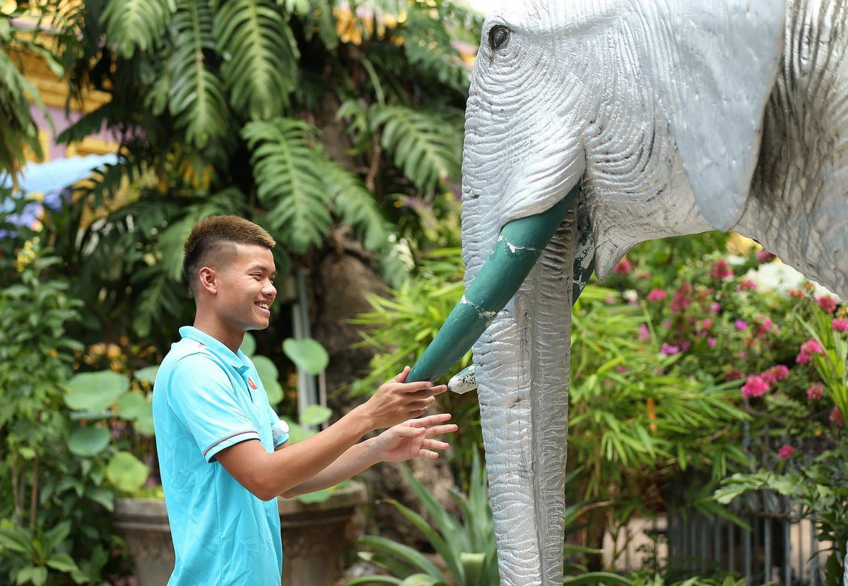 Tiền đạo Văn Tùng cầu may với tượng voi trong chùa Wat Ounalom.