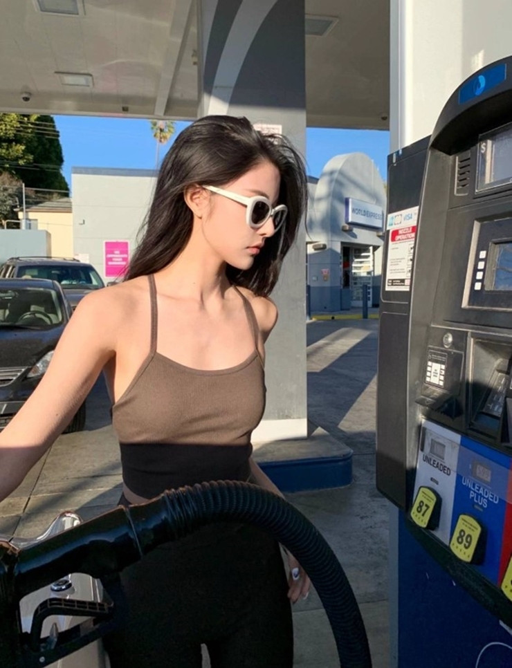 Cô gái này lại chọn trang phục thể thao gồm áo hai dây là legging để đi đổ xăng.