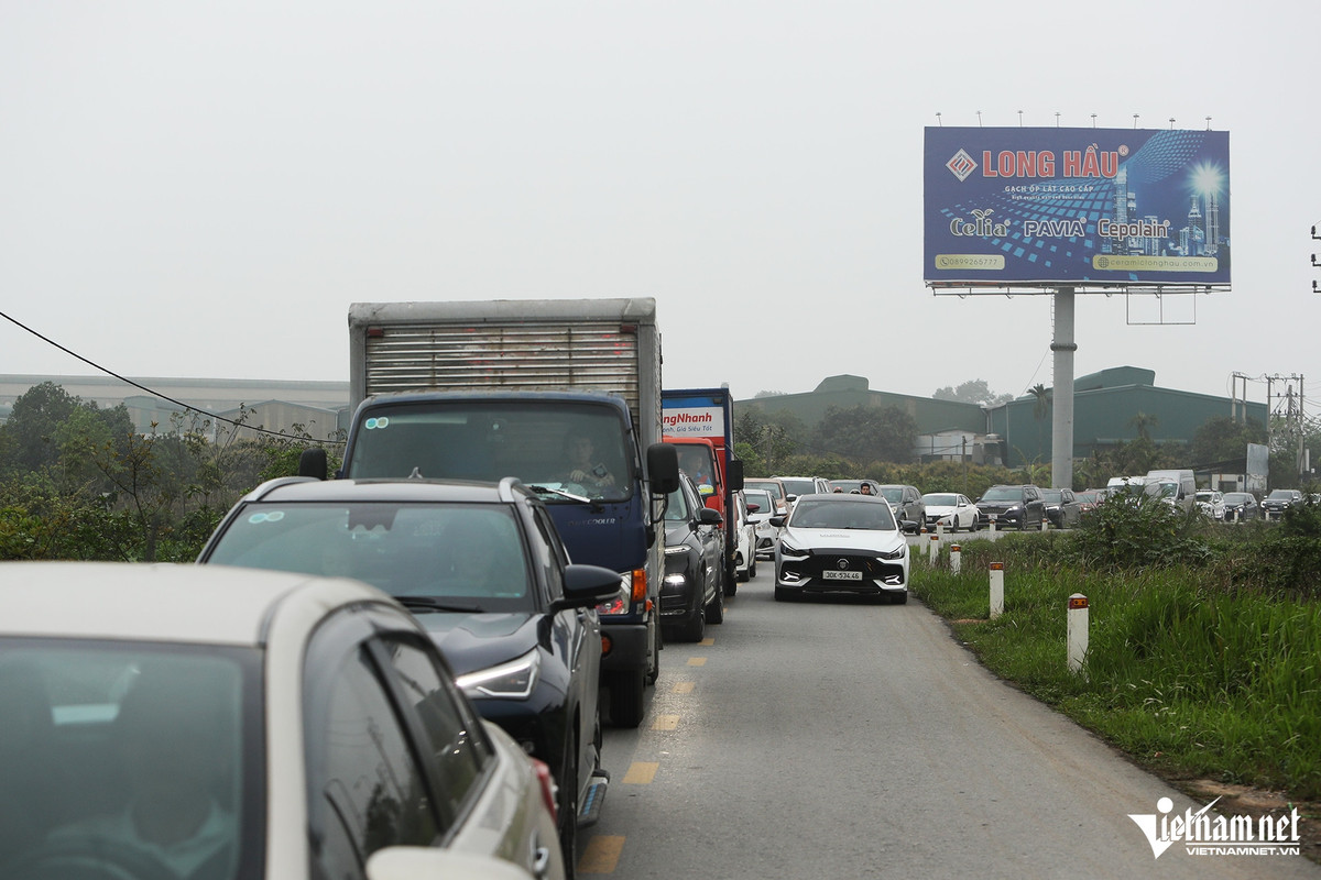Tình trạng ùn tắc không chỉ diễn ra ở trên đường cao tốc mà hai chiều của đường gom cũng di chuyển khó khăn. Dòng ô tô, xe máy bị ùn kéo dài khoảng 5km.