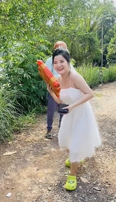 Trước đó, mạng xã hội cũng từng xôn xao với hình ảnh cô dâu mặc váy cưới đỏ rực đang làm lễ cưới nhưng vẫn tranh thủ đón shipper để lấy đồ.