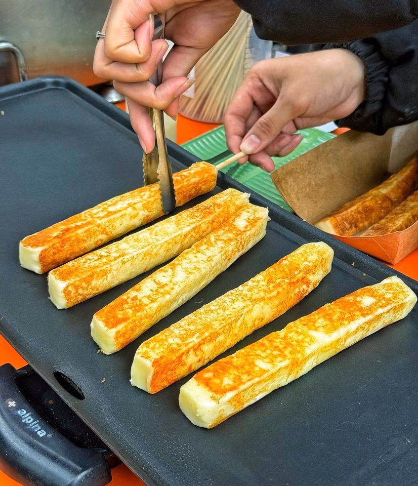 Không chỉ là món ăn vặt "gây nghiện", bánh phô mai sữa nướng còn được yêu thích vì sự thú vị trong trải nghiệm thưởng thức – vừa xem chế biến trực tiếp, vừa tận hưởng hương thơm phô mai béo ngậy, khó cưỡng.