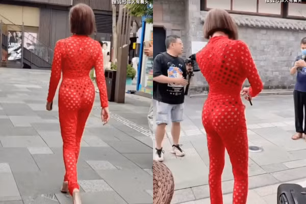 Chiếc váy cô mặc đầy lỗ thủng khắp người, ôm bó sát cơ thể, rõ ràng không phải là kiểu trang phục thích hợp để đi dạo phố nơi đông người.