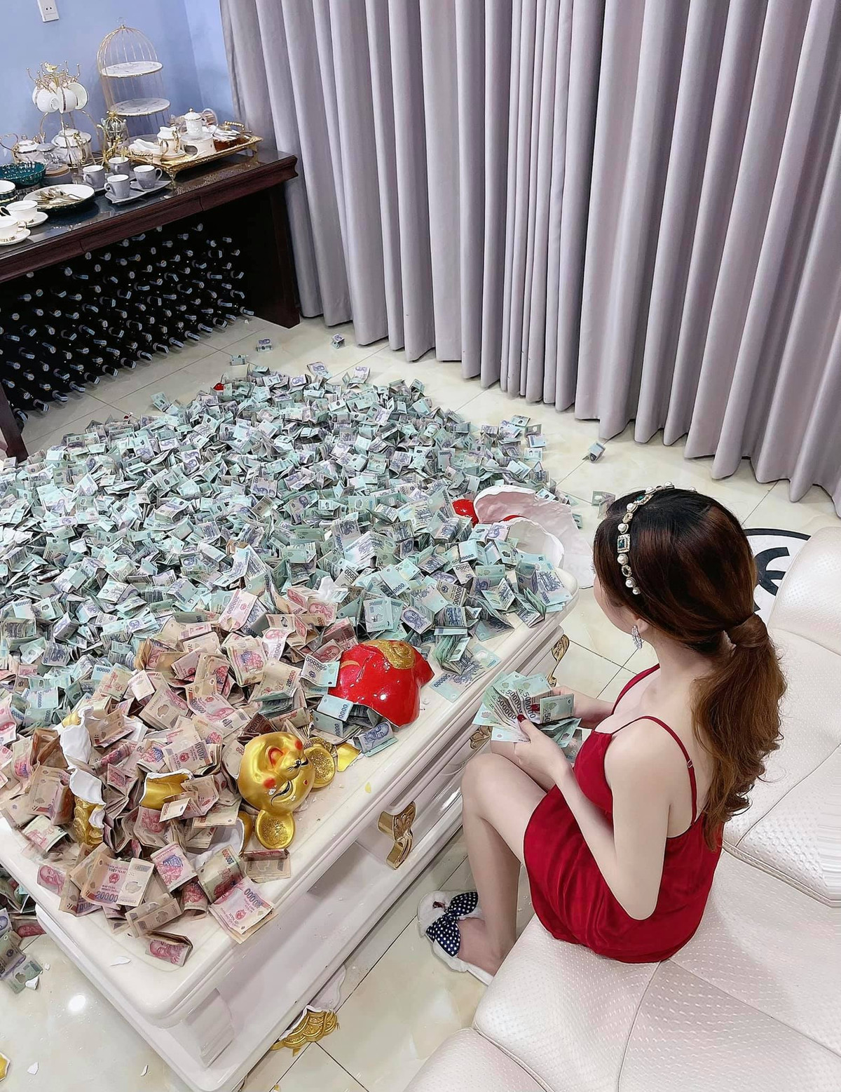 Sau đó, Ngọc phải dùng tay để kéo từng xấp tiền ra, sau đó đặt giữa nền nhà.