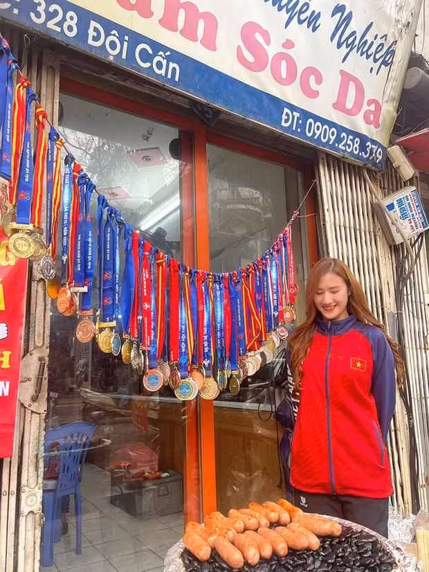 Đi ngang qua con phố Đội Cấn (Hà Nội) đông đúc, tập nập, nhiều người không khỏi tò mò khi nhìn thấy quầy lạp xưởng nướng đá treo đầy những tấm huy chương vàng, huy chương bạc.